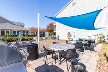 Indigo apartments charcoal grills and seating area